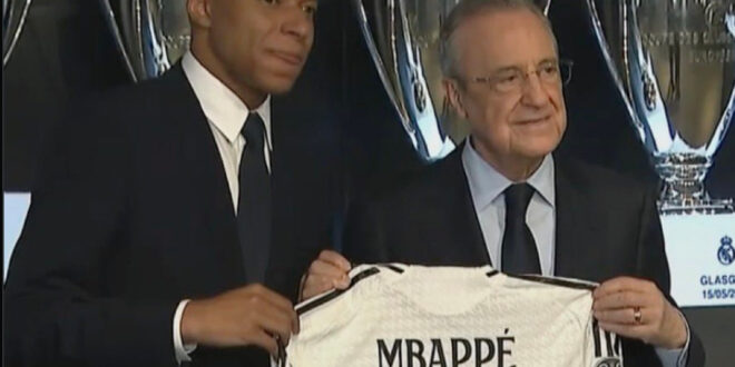 Photo: Kylian Mbappe holds his new Real Madrid shirt with Florentino Perez